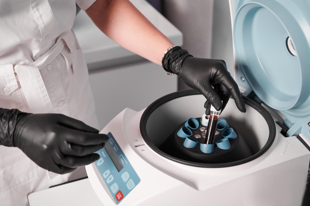 researcher-putting-test-tube-into-laboratory-centrifuge.jpg