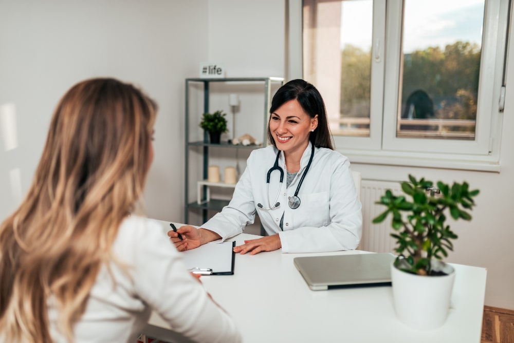 healthcare-and-medicine-concept-friendly-female-doctor-in-conversation-with-female-patient-min.jpg